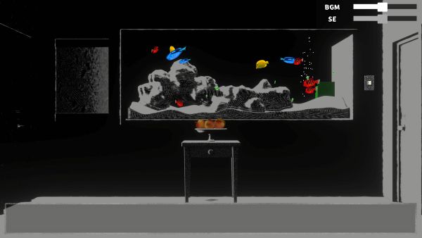 Colorful fish in a tank, set in a dark room. There is a small table in front of the tank with three round objects.