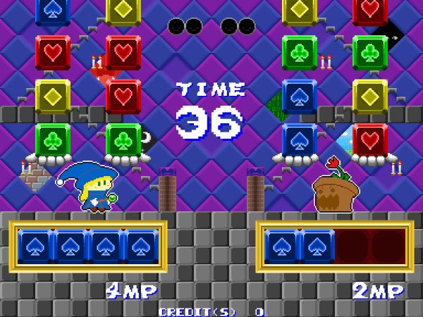 A witch facing off against a potted flower monster in Nitacle Witch, with two columns of blocks resting on a pair of outstretched hands, and a row of blue cubes lined up underneath.